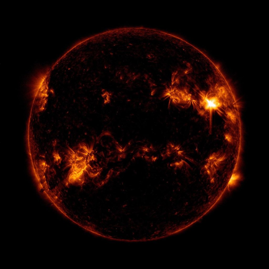 the Sun imaged by a space telescope with a bright flare at its limb